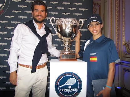 Coach and player pose next to the Longines Future Tennis Aces trophy.