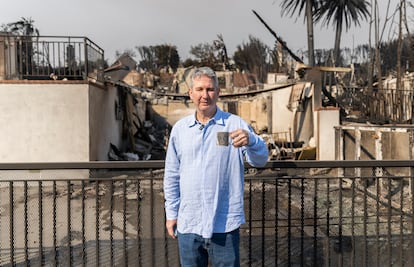 Steven Kolker poses next to his mug, the only thing he was able to salvage from his home after the Pacific Palisades fire in Los Angeles.