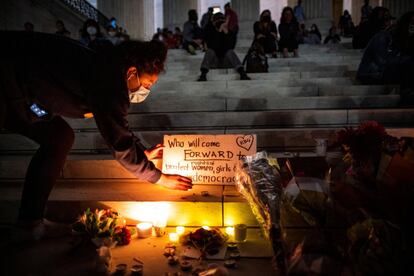 Una mujer coloca una vela en un altar improvisado por la muerte de la decana del Tribunal Supremo de los Estados Unidos Ruth Bader Ginsburg, en Washington.