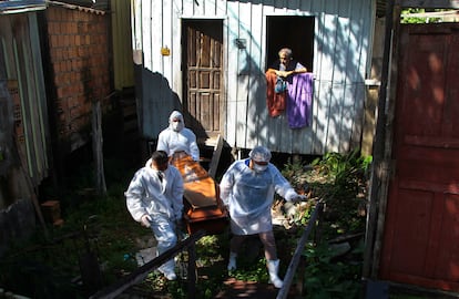 Empleados municipales recogen el cadáver de una nonagenaria fallecida por complicaciones de la covid en su casa de Manaos.