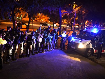 Reporters take pictures of a police van, allegedly carrying soccer player Dani Alves, outside the Barcelona courthouse, Spain, Friday, Jan. 20, 2023.