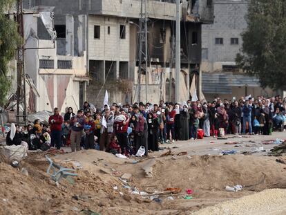 Dozens of Palestinians wait on Wednesday before leaving northern Gaza through a humanitarian corridor.