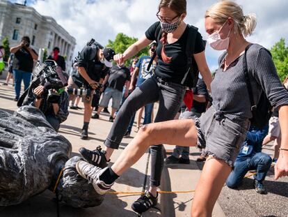 Manifestantes pisam na cabeça de uma estátua de Cristóvão Colombo em St. Paul, Minnesota, em junho de 2020.