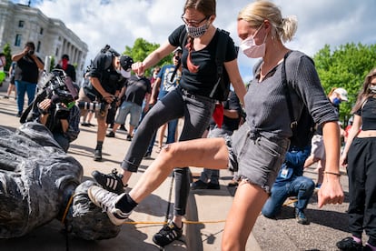 Protesters kicking a toppled Columbus statue in St. Paul, Minnesota, in June 2020.