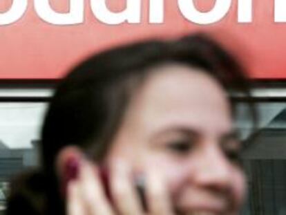 Una mujer saliendo de una tienda de Vodafone