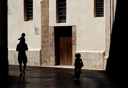 A man out for a walk with two children in downtown Valencia on Wednesday. 