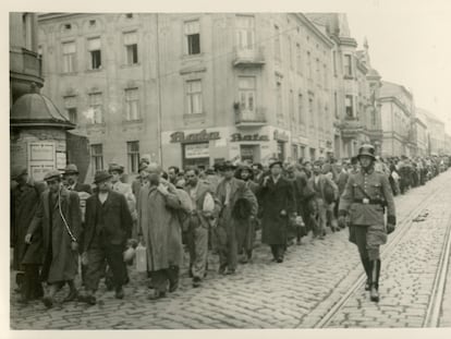 A German officer escorts a convoy of prisoners along a street in Tarnów, Poland, June 1940.