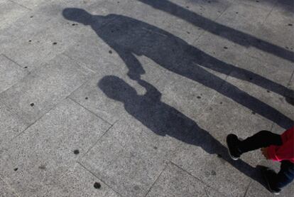 La sombra de C.H., de 35 años, con su hija de 16 meses, ayer, en Madrid.