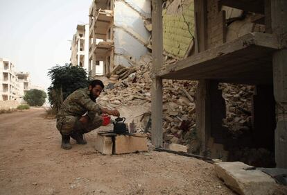 Un combatiente rebelde sírio del Frente de Liberación Nacional (NLF) prepara el té en el distrito de Al-Rashidin, controlado por los rebeldes, en el campo de Aleppo occidental, próximo a la provincia de Idlib.