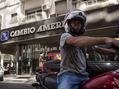 Un motociclista circula por la puerta de una de las casas de cambio más conocidas de Buenos Aires.