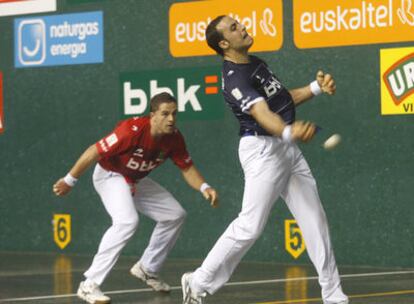 Irujo golpea la pelota con la derecha, con Olaizola, detrás, a la expectativa.