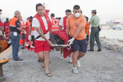 Equipos de Salvamento Marítimo y de la Cruz Roja atienden a uno de los 38 inmigrantes llegados al puerto de Motril.