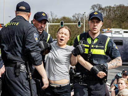 The Hague (Netherlands), 06/04/2024.- Swedish climate activist Greta Thunberg (2-R) reacts as she is detained by police officers during a climate demonstration blocking the A12 highway in the Hague, the Netherlands, 06 April 2024. Thunberg joined the 37th highway blockade called by the Extinction Rebellion as new international actions against fossil subsidies were announced during the action. (Protestas, Países Bajos; Holanda, La Haya) EFE/EPA/RAMON VAN FLYMEN