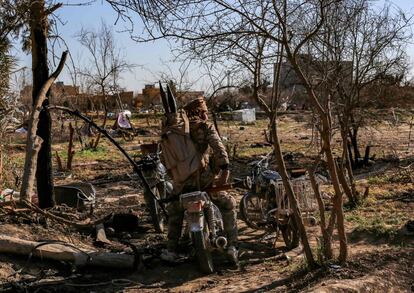 Milicianos de las Fuerzas Democráticas Sirias (SDF, en sus siglas inglesas) reposan sobre una motocicleta en un campamento improvisado para yihadistas del ISIS y sus familias en Baghuz, el 9 de marzo.