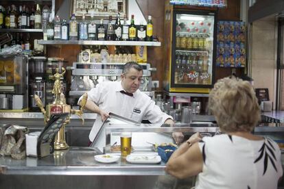 Un camarero en la barra de un bar de Sevilla.