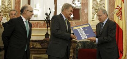 El ministro de Hacienda y Administraciones Públicas, Cristóbal Montoro, junto al presidente del Congreso, Jesús Posada (centro), y el presidente de la Comisión de Presupuestos, Alfonso Guerra (derecha)