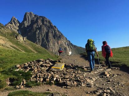 Excursionistas en el collado de Soum de Pombie con la cara sur del Midi d’Ossau al fondo, en el Pirineo francés.