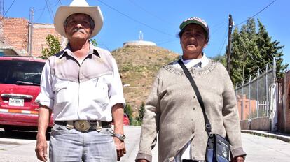 Dois moradores em frente do morro onde será construída a estátua