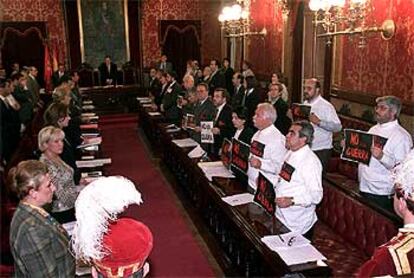 Los ediles del PP (a la izquierda de la foto) y los de la oposición guardan cinco minutos de silencio al empezar el pleno.