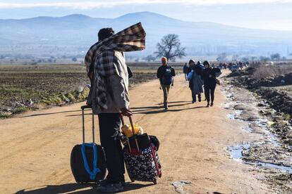Migrantes y refugiados a pie después de cruzar la frontera con Macedonia, en la localidad serbia de Miratovac.