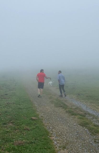 Kepa Acero, derecha, y el escalador Alex Txikón conversan entre la niebla del Monte Gorbea.