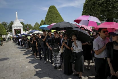 Tailandeses esperan largas colas para participar en una ceremonia de baño ritual delante de un retrato del rey Bhumibol Adulyadej en el pabellón Sahathai Samakom dentro del Gran Palacio, en Bangkok (Tailandia).