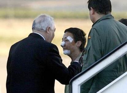 El ministro de Asuntos Exteriores, Miguel Ángel Moratinos, recibe en la base aérea de Torrejón a una de las heridas en Yemen.