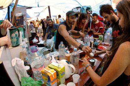 Some of the protestors in Puerta del Sol having breakfast after spending the night camped out in the square.