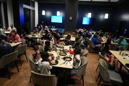 Evacuees eating at a hotel as Milton makes landfall on Florida's Gulf Coast in Tampa.