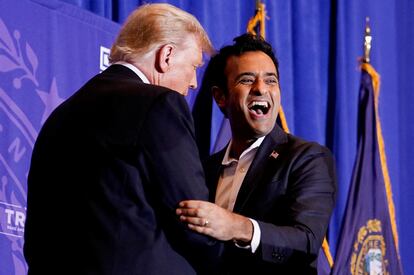 Vivek Ramaswamy, who ended his Republican presidential campaign, greets Republican presidential candidate and former U.S. president Donald Trump during a campaign rally ahead of the New Hampshire primary election.