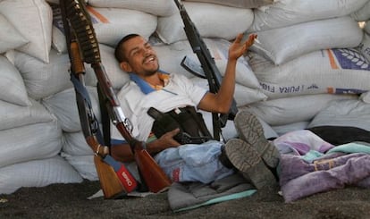 A member of the self-defense force relaxes at his post in Apatzingán.