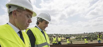 El ministro de Fomento, Íñigo de la Serna (d), acompañado por el presidente de Adif, Juan Bravo, durante la visita realizada a las operaciones de montaje de la vía de alta velocidad ferroviaria que se desarrollan entre Cáceres y Mérida