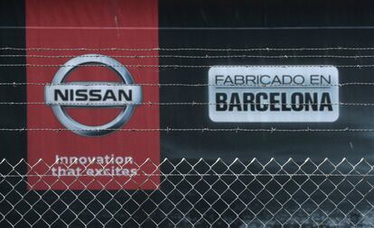 FILE PHOTO: The logo of Nissan is seen through a fence at Nissan's factory at Zona Franca in Barcelona, Spain, May 26, 2020. REUTERS/Albert Gea/File Photo