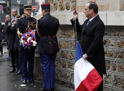 El presidente francés, François Hollande, sujeta una bandera francesa durante el homenaje a las víctimas en el primer aniversario de la masacre en la capital francesa.