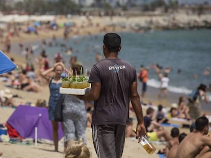 Un vendedor ambulante con una bandeja de mojitos en la Barceloneta.