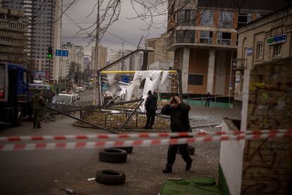 Police officers inspect area after an apparent Russian strike in Kyiv Ukraine, Thursday