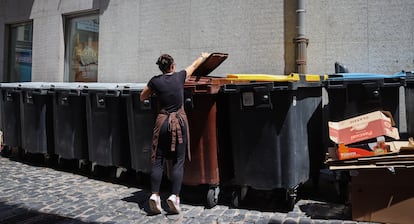 Un mujer coloca una bolsa de basura en un contenedor en Segovia el pasado 9 de julio.