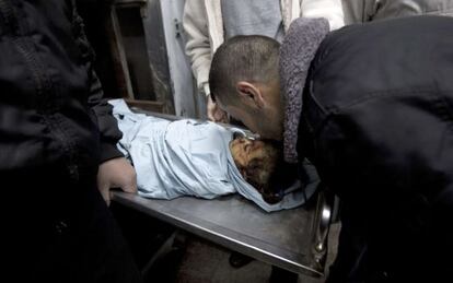 Un familiar besa el cad&aacute;ver de la ni&ntilde;a muerta en un bombardeo en Gaza.