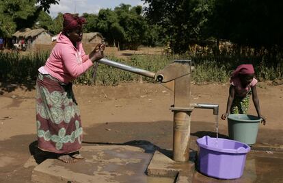 Una mujer y una niña extraen agua en Mzingo (Malaui).