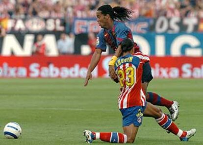 Ronaldinho intenta irse del centrocampista francés del Atlético Luccin.