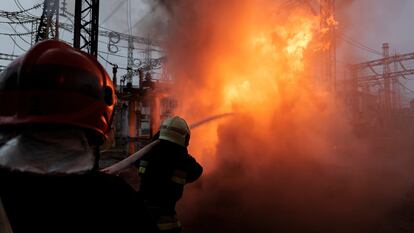 A firefighter battles a fire sparked by a Russian attack on a power plant in Kharkiv on March 22.