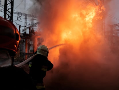 A firefighter battles a fire sparked by a Russian attack on a power plant in Kharkiv on March 22.