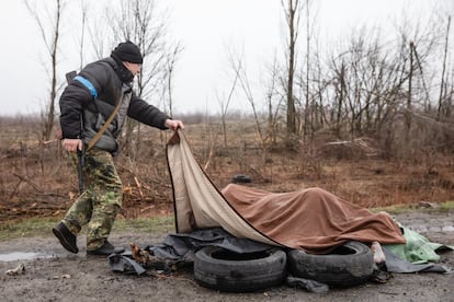 Un miembro de la fuerza de Protección Civil Ucrania observa a cuatro civiles muertos debajo de una manta en una carretera en Bucha, a 20 kilómetros de la capital, el sábado. Las ejecuciones sumarias documentadas en base a entrevistas con testigos se produjeron el 4 de marzo en esta localidad, al noroeste de la capital, y el 27 de febrero en Starii Bikiv, en la región de Chernihiv.