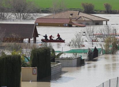 Una lancha de rescate navega entre las parcelas anegadas cerca del aeropuerto de Córdoba.