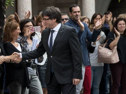 Catalan regional premier Carles Puigdemont greets his employees the day after the referendum.