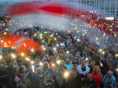 Manifestantes opositores encienden las luces de sus móviles, el miércoles en la plaza de la Independencia de Minsk.