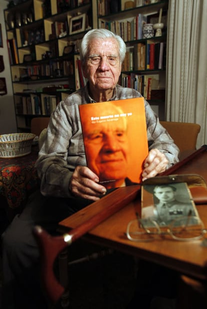 Eugenio Azcárraga in his Valencia home, showing the book he has written.