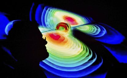 Cientista observa representação das ondas gravitacionais.