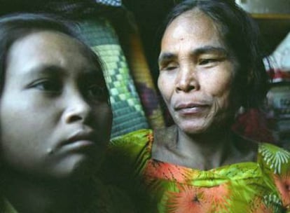 La joven hallada en la selva, a la izquierda, junto a su supuesta madre, Rochom Soy, en su casa de Oyadao, en la provincia camboyana de Ratanakiri.