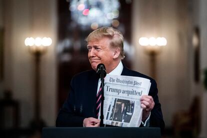 Then-president Donald Trump holds up a copy of 'The Washington Post' on February 6, 2020.